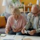Senior couple reviewing 401k balance and retirement documents