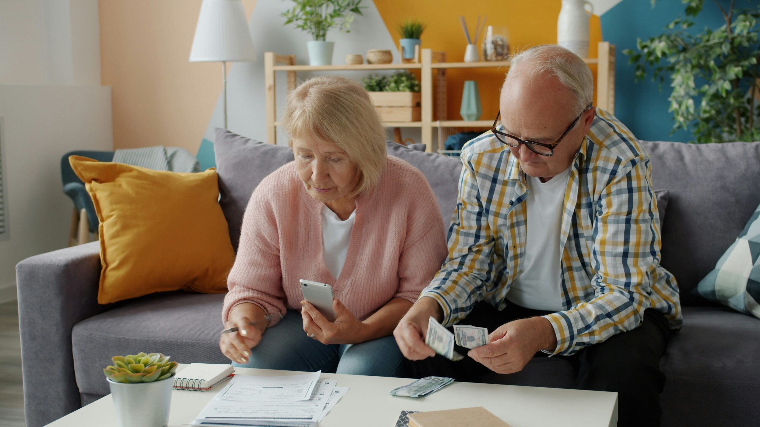Senior couple reviewing 401k balance and retirement documents