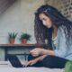 Average credit card debt in 2026 — person reviewing credit card bills and finances online