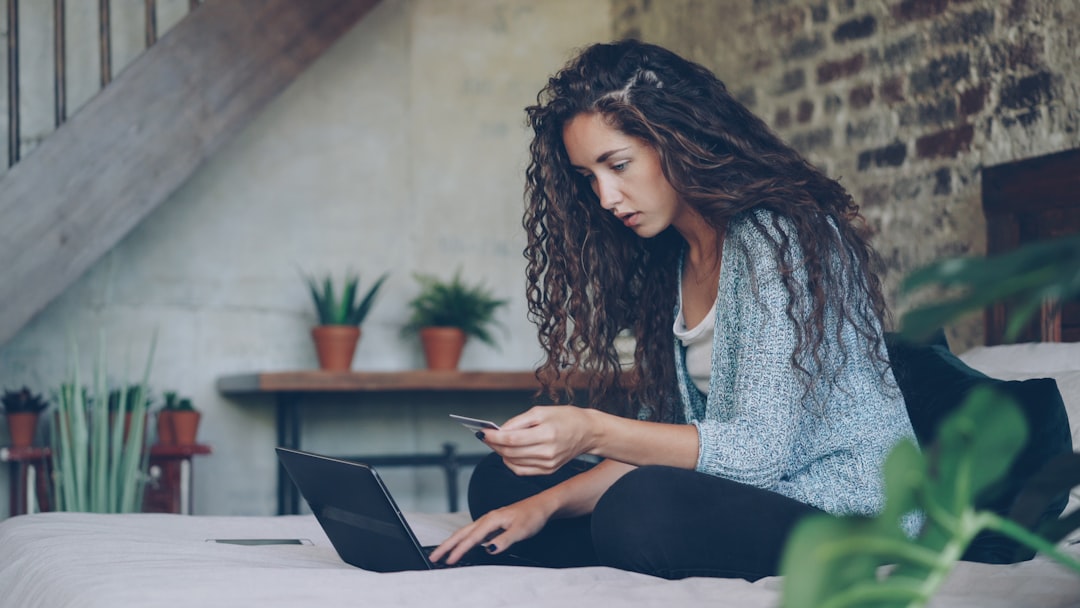 Average credit card debt in 2026 — person reviewing credit card bills and finances online