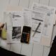 Person calculating debt consolidation loan payments with a calculator and bills