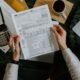 Debt settlement vs bankruptcy paperwork with calculator and laptop used to compare payoff costs