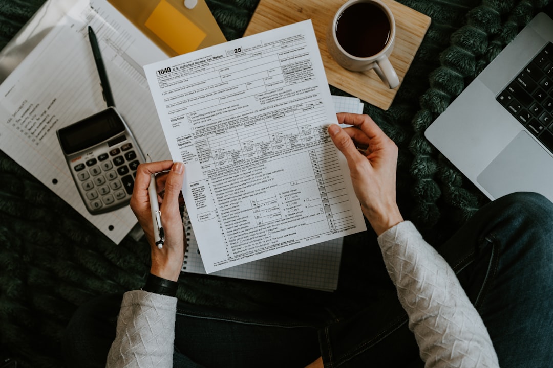 Debt settlement vs bankruptcy paperwork with calculator and laptop used to compare payoff costs