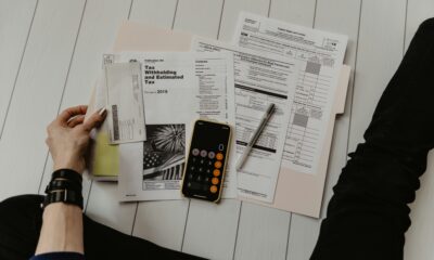 Calculator and paperwork used to work out debt-to-income ratio
