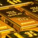 Gold bars representing gold vs stocks vs real estate comparison
