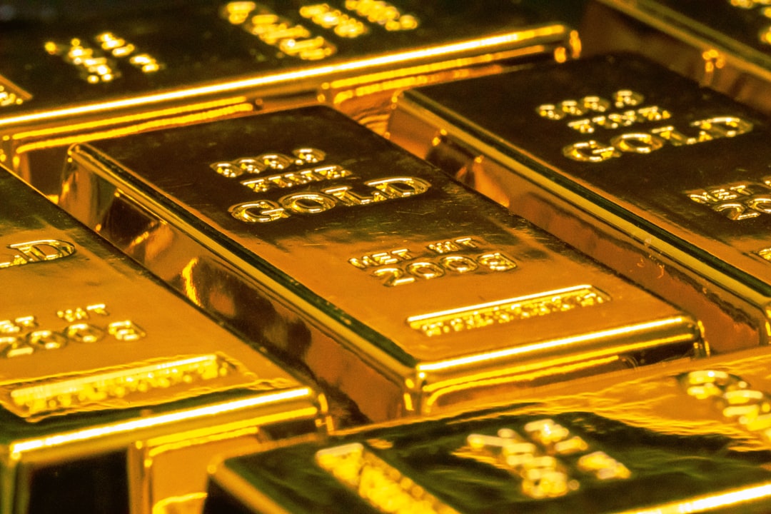 Gold bars representing gold vs stocks vs real estate comparison