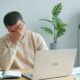 Stressed worker reviewing paycheck and bills, illustrating how to stop wage garnishment for debt