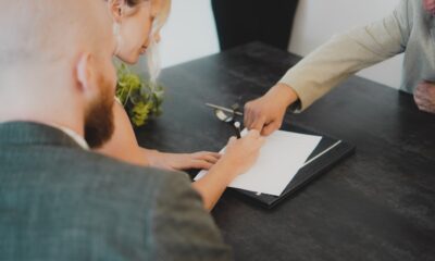 Couple reviewing paperwork on how to pay off your car loan early
