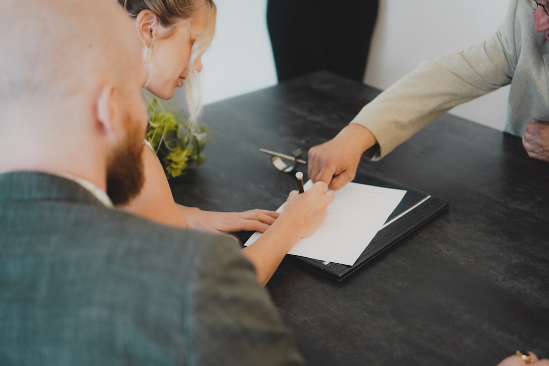 Couple reviewing paperwork on how to pay off your car loan early