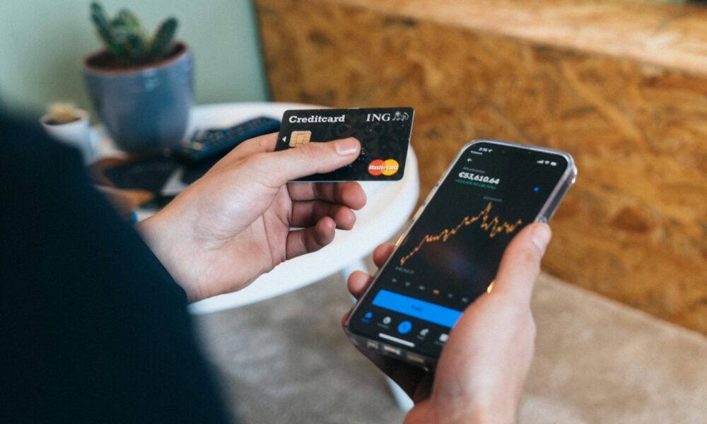 Improve your credit score fast: person checking credit card and score on smartphone