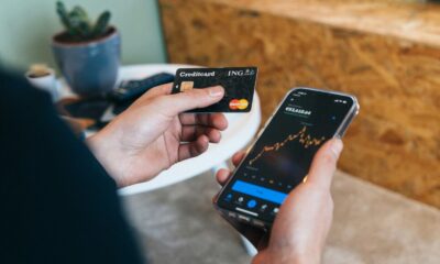 Improve your credit score fast: person checking credit card and score on smartphone