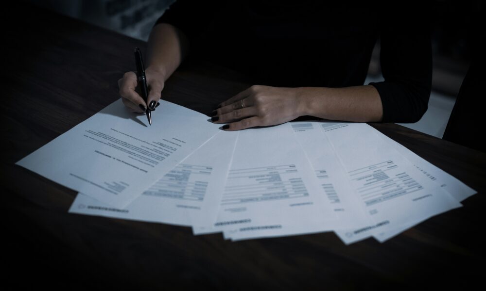 Person signing a medical debt settlement agreement
