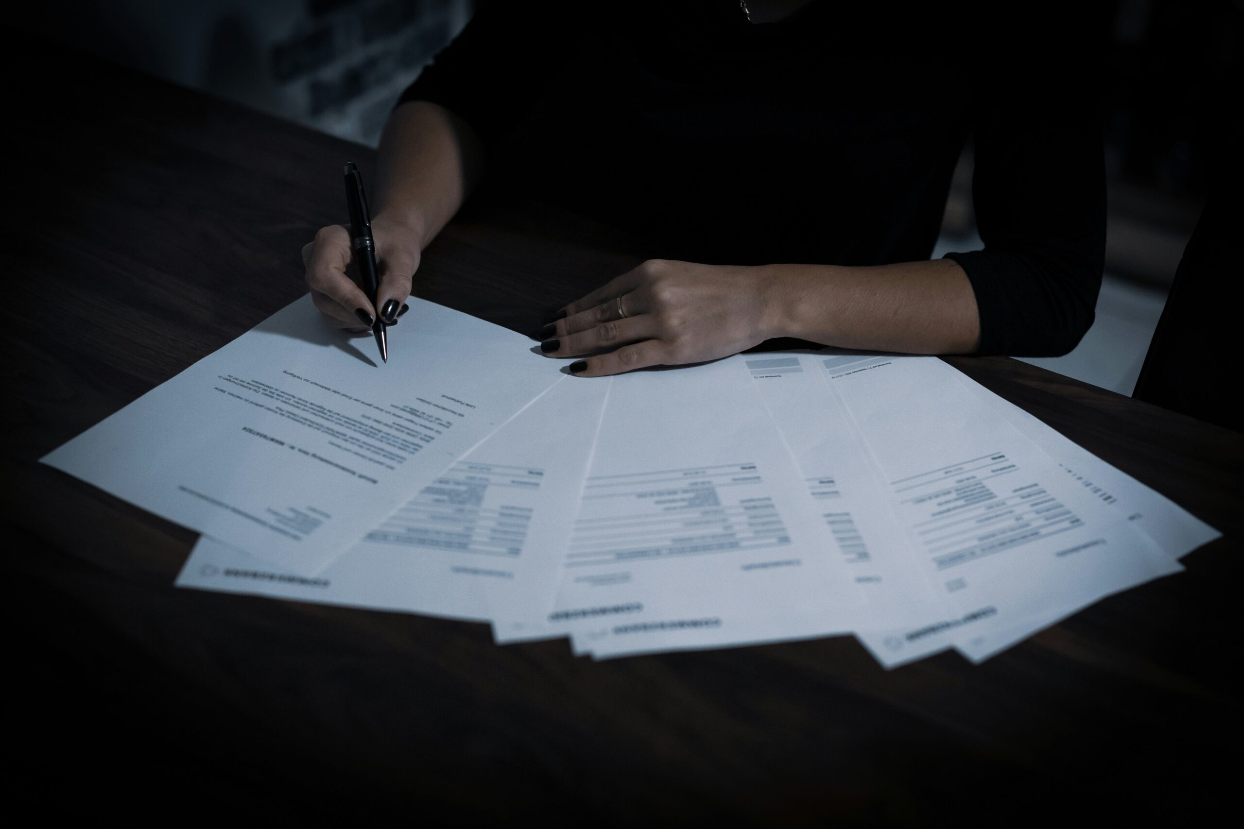 Person signing a medical debt settlement agreement