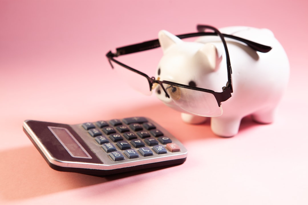 Calculator and piggy bank illustrating the decision to pay off debt or invest first