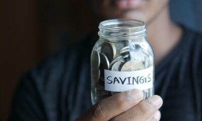 Saving habits jar with coins representing steps toward financial independence