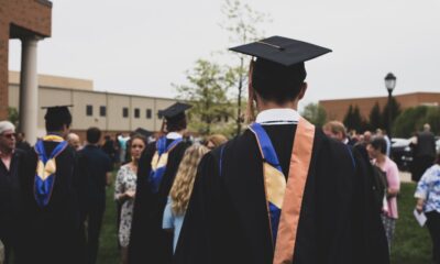 Student loan forgiveness in 2026 graduate celebrating with diploma