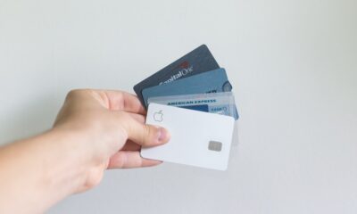 Credit card debt statistics 2026 illustrated by a person holding multiple credit cards