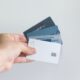 Credit card debt statistics 2026 illustrated by a person holding multiple credit cards