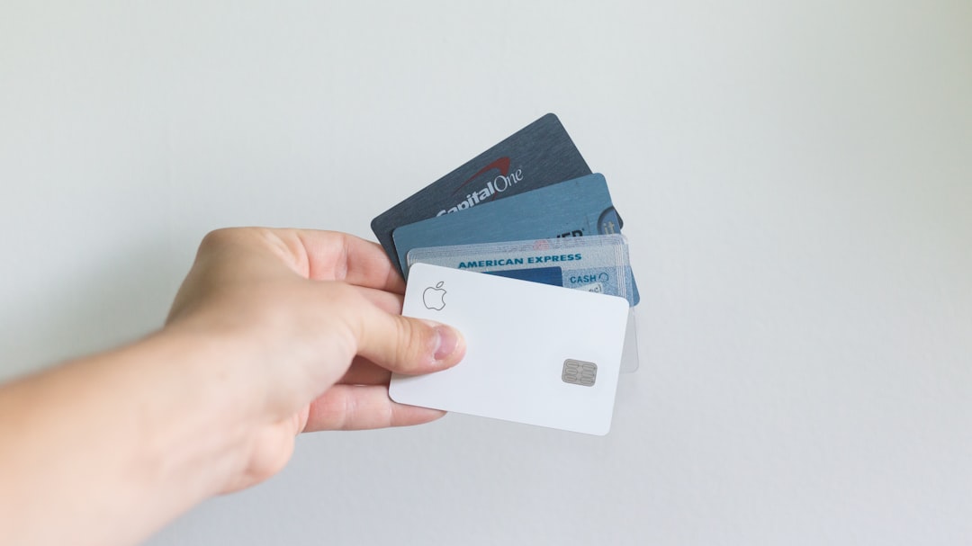 Credit card debt statistics 2026 illustrated by a person holding multiple credit cards