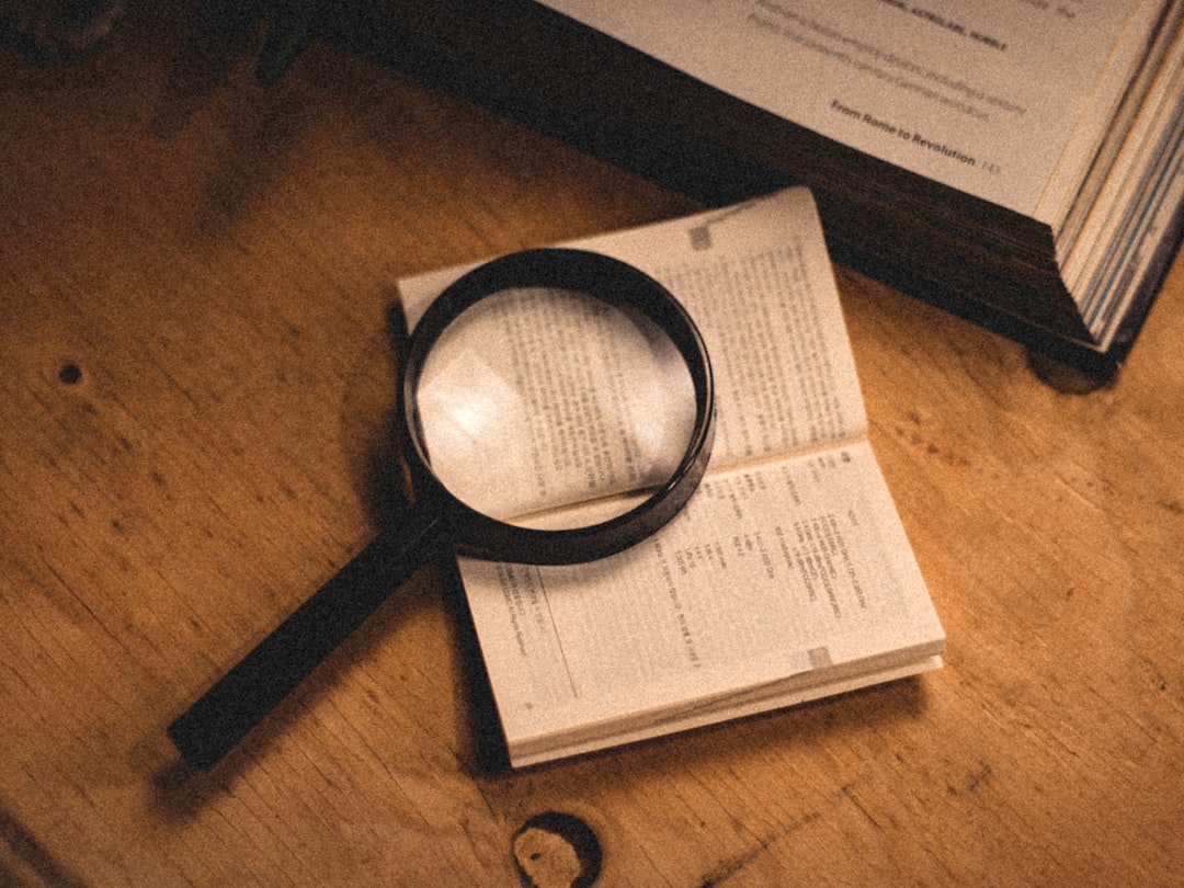 Person reviewing a credit report with a magnifying glass to spot credit report errors